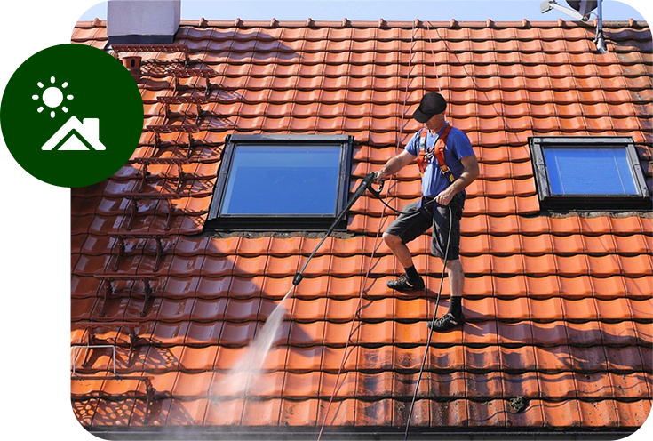 A man is cleaning the roof of a house.