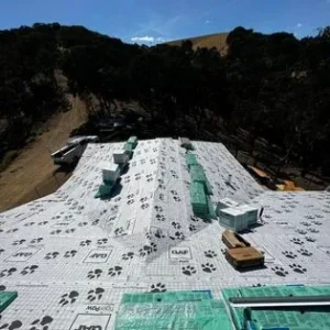 A building that has been covered in green plastic.