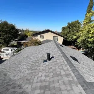 A roof that has been repaired with asphalt shingles.
